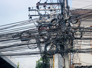 The chaos of cables and wires for commutation on every street in Bangkok, Thailand. 