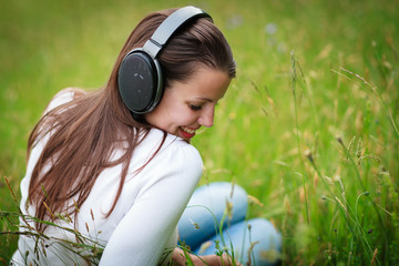 portrait of a pretty young woman listening to music 