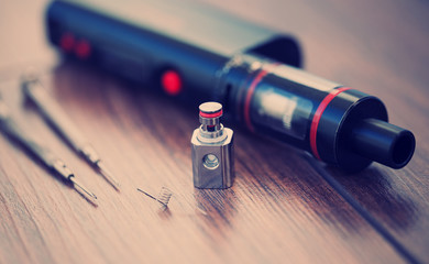 Vaping device and spare parts. Modern electronic cigarette and tools