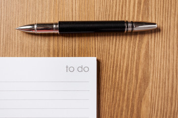 to do list and pen on wooden background