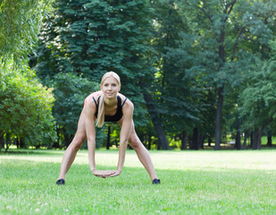 The beautiful blonde stretching outdoors