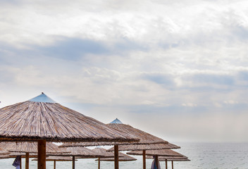 Straw umbrella on beautiful beach close