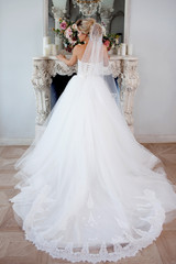 Fototapeta na wymiar Charming young bride in luxurious wedding dress. Pretty girl, photo Studio