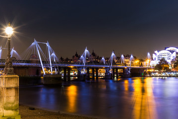 Fototapeta na wymiar Golden Jubilee Bridges reflecting in the Thames at night in Lond