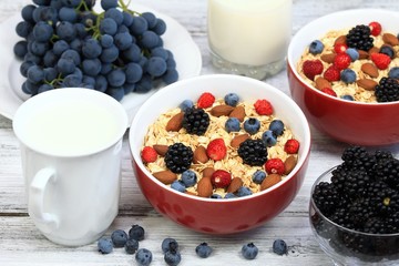 Oatmeal  breakfast, wild strawberries, blueberries, blackberries, grapes, almonds