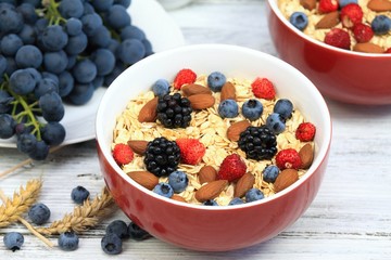 Oatmeal  breakfast, wild strawberries, blueberries, blackberries, grapes, almonds
