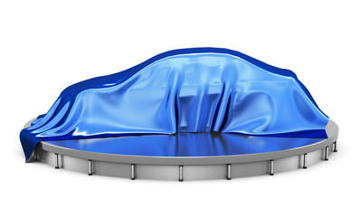 Car on the podium covered with a blue satin cloth before present