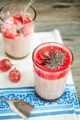 oatmeal pudding with strawberry sauce and grapes, rustic