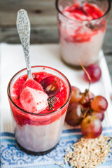 oatmeal pudding with strawberry sauce and grapes, rustic