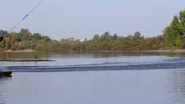 Ryder makes landing a wakeboard and a reversal. Beautiful water fan. Spray.
