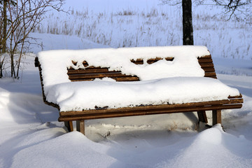 Wooden bench in the snow