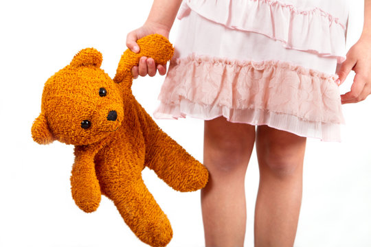 little girl with her teddy bear friend in hand