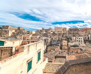 Naklejka premium panoramic view of typical stones (Sassi di Matera) of Matera under blue sky