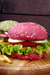 Different colours of burgers and fries