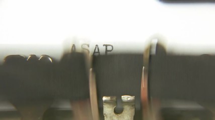 Typing the words ASAP As soon as possible - with an old vintage typewriter. Macro detail shot.
