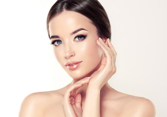 Beautiful Young Woman with Clean Fresh Skin close up . Skin care face . Cosmetology
