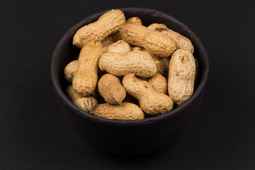 Raw peanuts shells in bowl