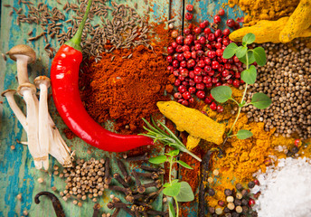 Various colorful spices on wooden table