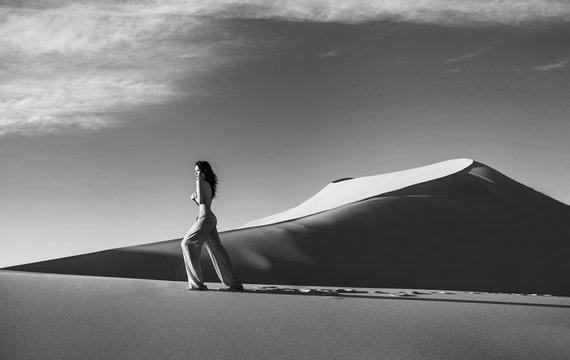 Beautiful sexy asian woman in desert. Black and white photo