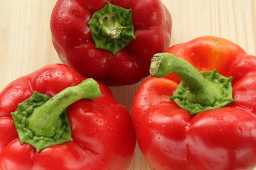 three peppers on wooden