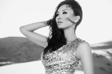 Beautiful sexy asian woman in desert. Black and white photo