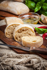 Sliced ciabatta bread on cutting board.