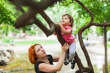 Courageous girl climbing on tree