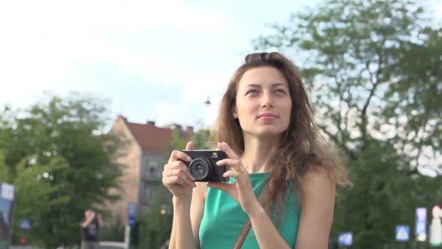 Girl doing photos of the view and looking satisfied, steadycam shot, slow motion shot
