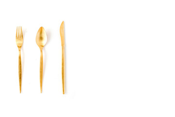 golden fork, spoon, knife isolated on white. flat lay, top view