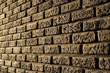 Brick wall of golden color, an illuminated beacon of light
