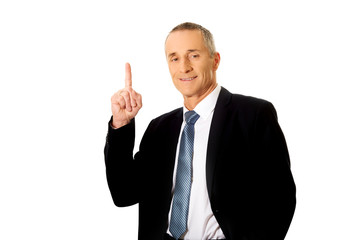 Businessman pointing upwards 