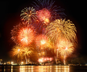 Bright beautiful big fireworks over the city. Panorama of the city at night
