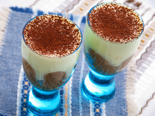 Mascarpone cream with cocoa. Shot over blue cloth.