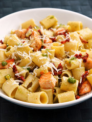 Italian Rigatoni with salmon and dried tomatoes. Vertical shot