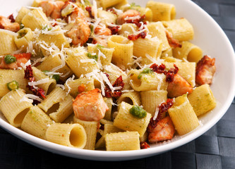 Italian Rigatoni with salmon and dried tomatoes. Horizontal shot