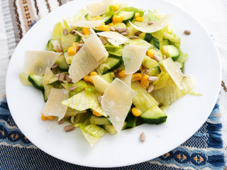 Healthy salad with cucumber, sweetcorn and parmesan cheese