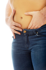 Naklejka premium Man touching silm woman's belly.