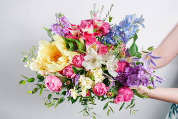 Luxury bouquets of mixed flowers in the hands women.