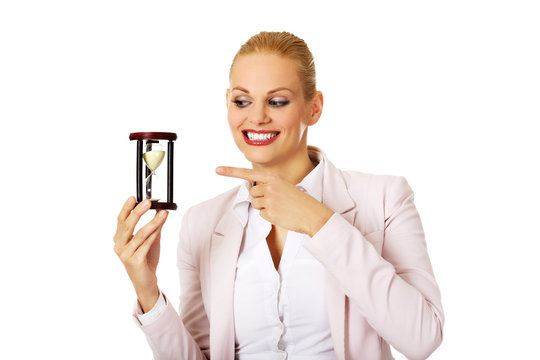 Young business woman holding hourglass.Time concept