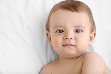 Cute baby sitting on the bed