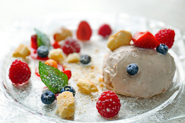 Ice cream with berries and mint leaves on plate