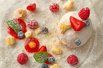 Ice cream with berries and mint leaves on plate