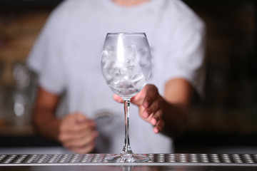 Barman preparing cocktail on bar counter