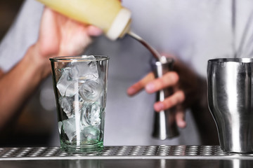 Barman preparing cocktail on bar counter