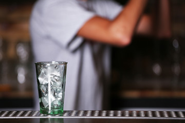 Barman preparing cocktail on bar counter