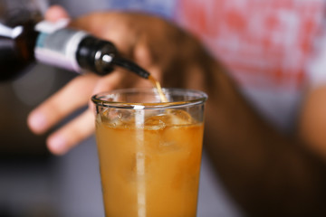 Barman preparing cocktail on bar counter