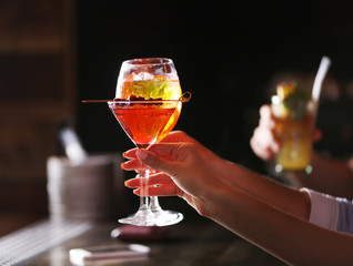 Women toasting with cocktails in bar