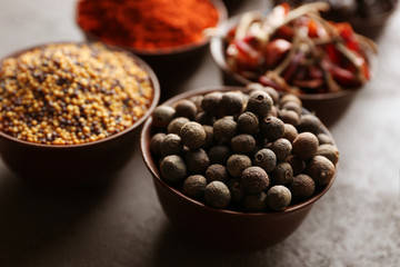 Different spices in bowls on table
