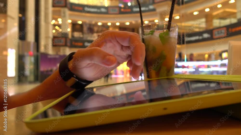 Poster hand gestures over tablet computer in cafe. bokeh background 4k shot