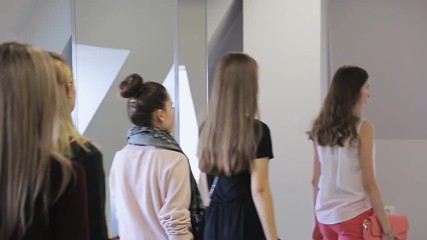 Close up portrait view of women walking in model school.